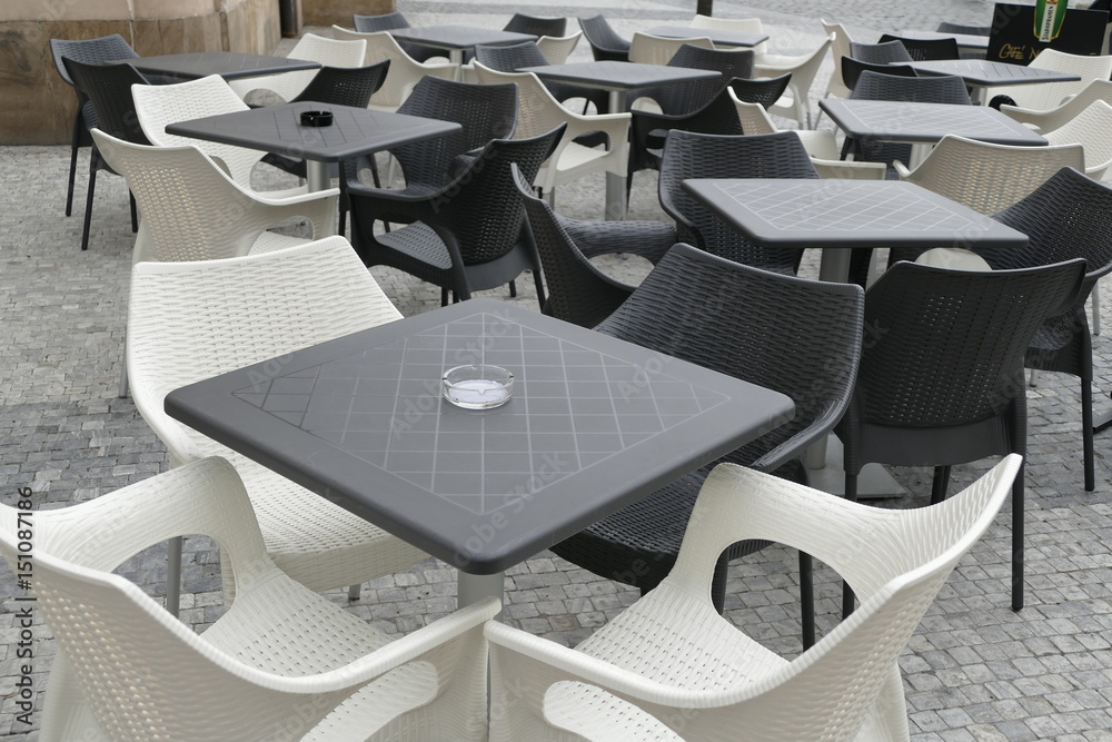 black and white outdoor chairs with tables