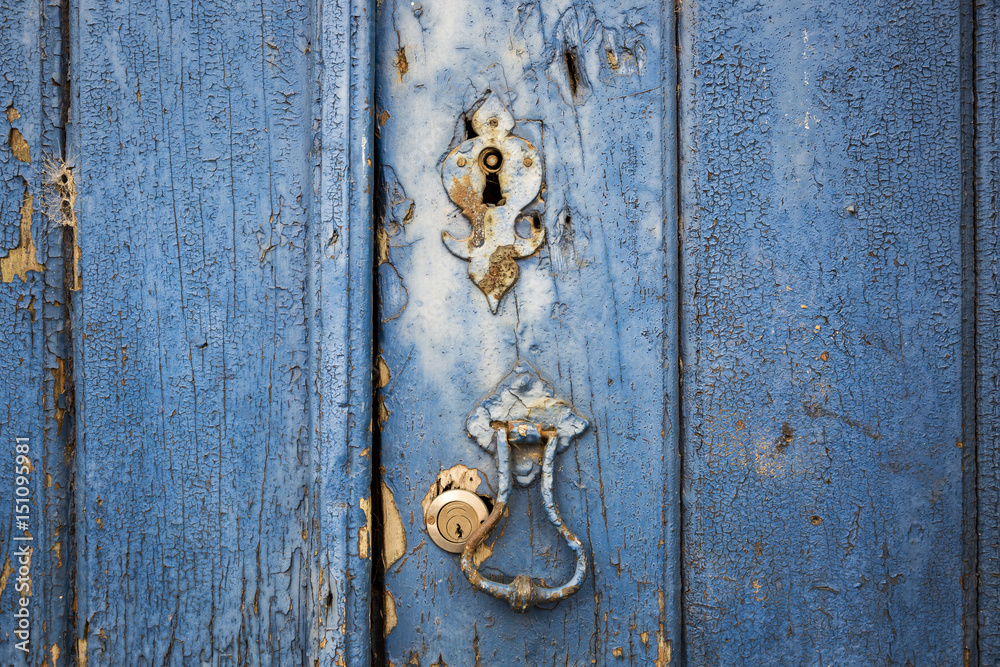 ancient door knocker and locks of an ancient blue wooden door ancient door knocker and locks of an ancient blue wooden door