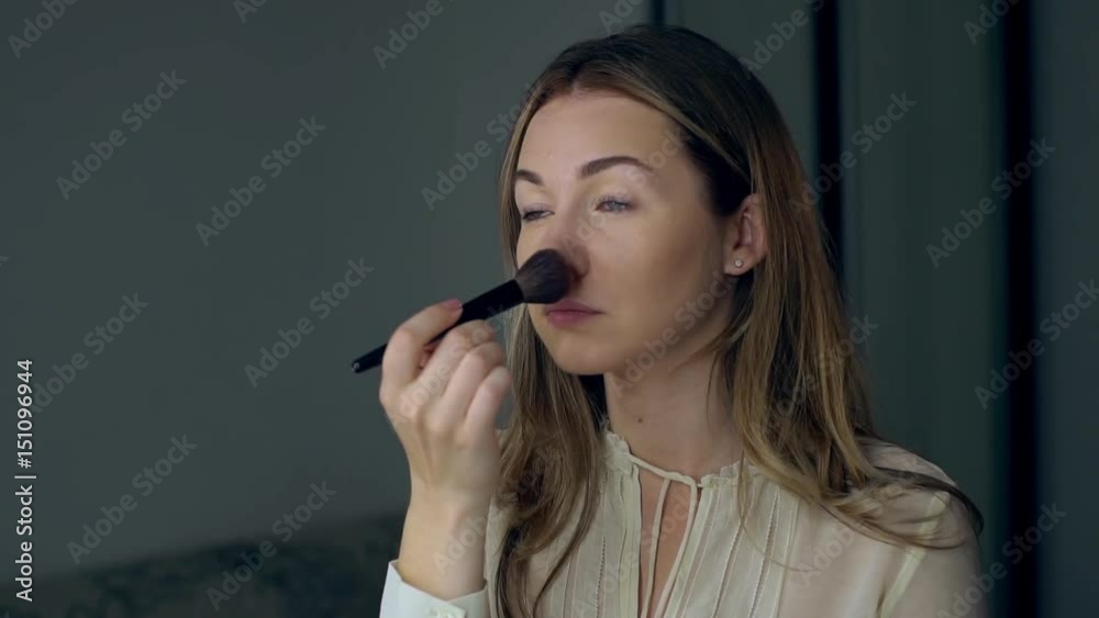 Gorgeous woman self applying smoky make-up. Girl in dress prepearing for evening celebration party. Perfect make up. Cosmetic Gorgeous woman self applying smoky make-up. Girl in dress prepearing for evening celebration party. Perfect make up. Cosmetic