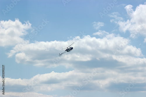 helicopter fly at cloudy sky background