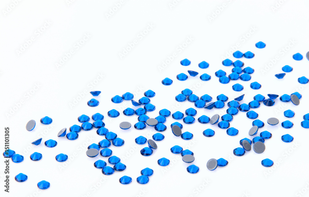 Precious sparkling rhinestones Capri blue colors on a white background.