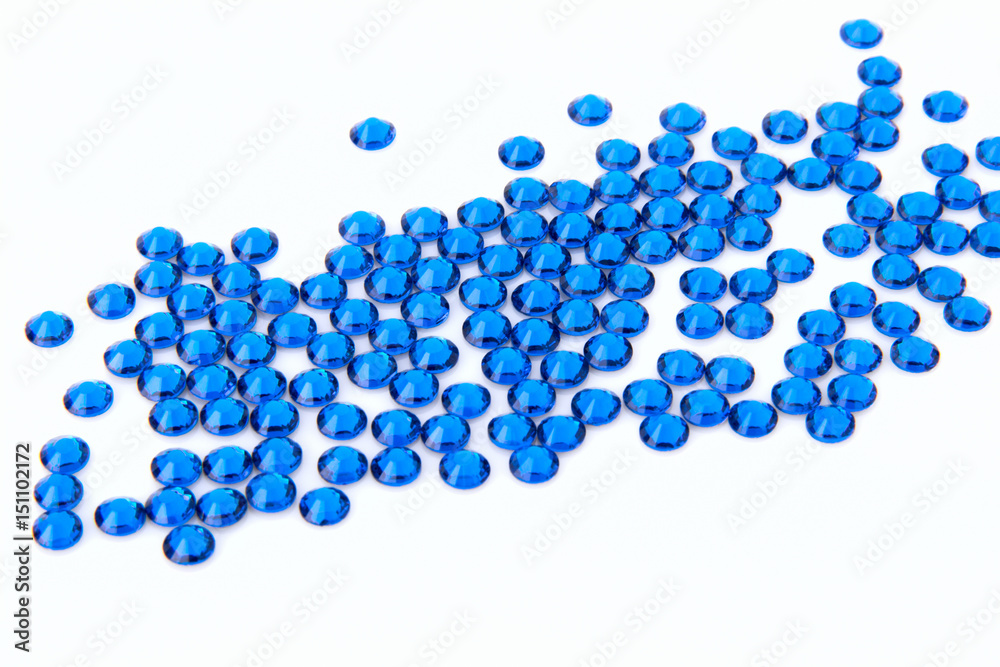 Precious sparkling rhinestones Capri blue colors on a white background. Precious sparkling rhinestones Capri blue colors on a white background.