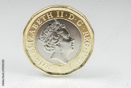 New British one pound sterling coin up close macro studio shot against a shiny reflective White background