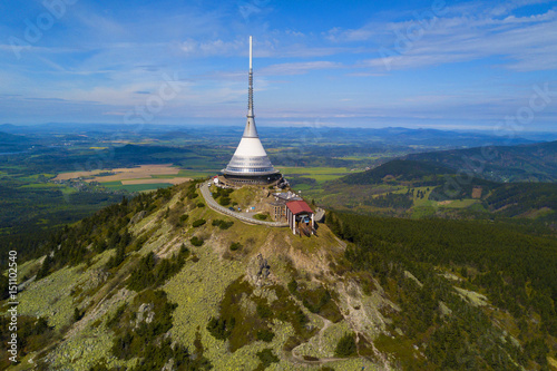 Aerial view of Jested tower on the top of Jested mountain 1 012 m (3,320 ft). Famous tourist attraction near Liberec in Czech republic, Europe. TV broadcast tower was built between 1963 and 1968. photo