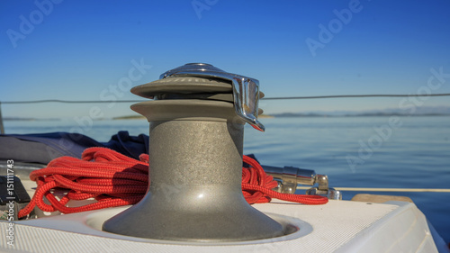 winch with red rope on yacht in the sea.