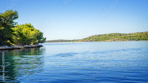 Sailing boat Moving In The Sea With Island in The Background