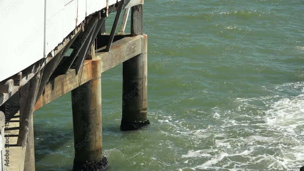 stormy waves splashing against concrete pillars stormy waves splashing against concrete pillars