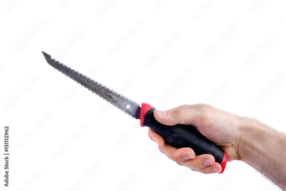 Obraz premium man's hand hold old saw with black and red handle isolated on white background