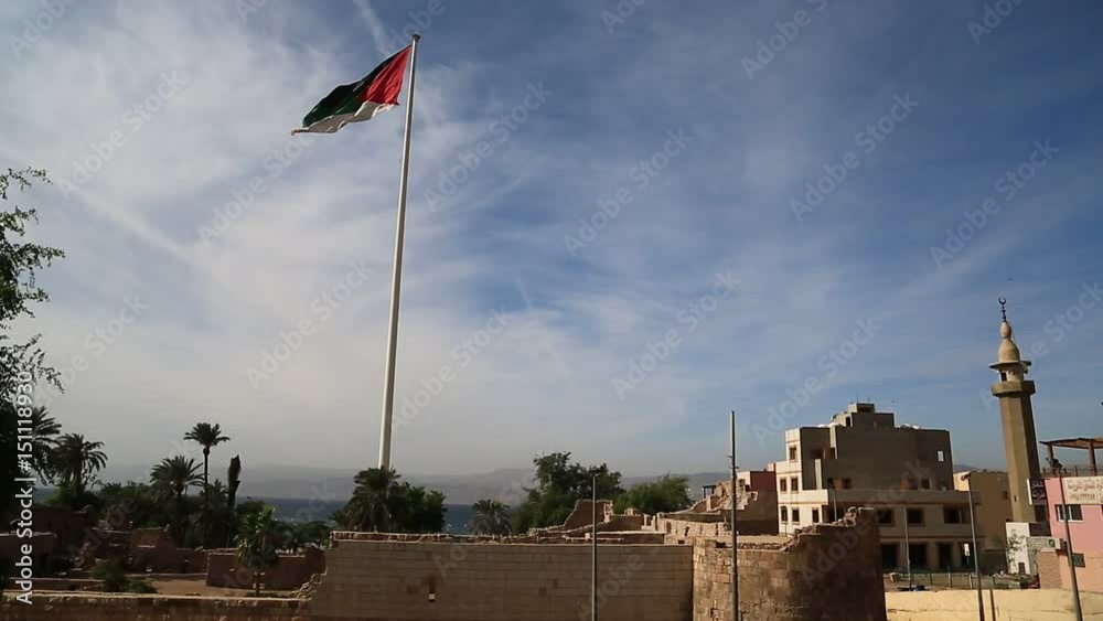 Aqaba fort near flag of the Arab Revolt in Aqaba, Jordan. Aqaba Castle, Mamluk Castle or Aqaba Fort, adjacent to fort is archaeological museum. Aqaba - only coastal city in Hashemite Kingdom of Jordan