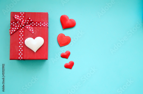 Gift box and red hearts on a blue background