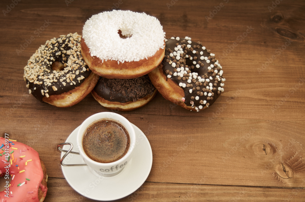 donuts and coffee on a wooden table donuts and coffee on a wooden table
