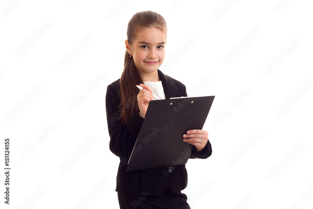 Little girl in black jacket holding pen and folder Little girl in black jacket holding pen and folder