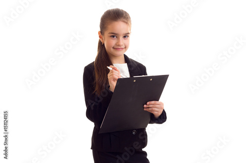 Little girl in black jacket holding pen and folder 