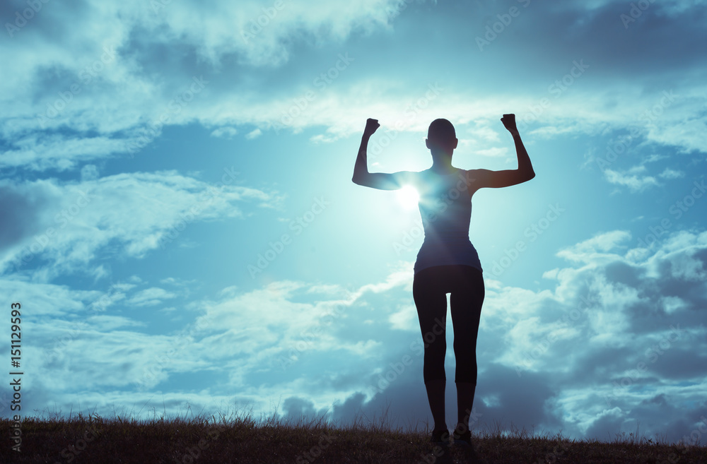 Silhouette of strong and confident woman flexing. Silhouette of strong and confident woman flexing.