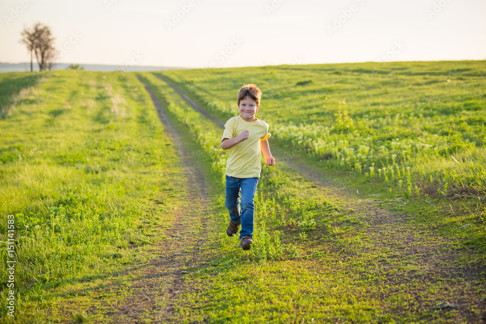 Little boy running on rural road