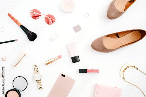 Beauty blog fashion concept. Female pink styled accessories: mobile phone, watches, sunglasses, cosmetics, shoes on white background. Flat lay, top view trendy feminine background.