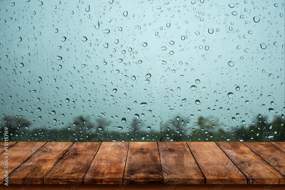Wood table with rain water drop on window. Stock Photo Adobe Stock