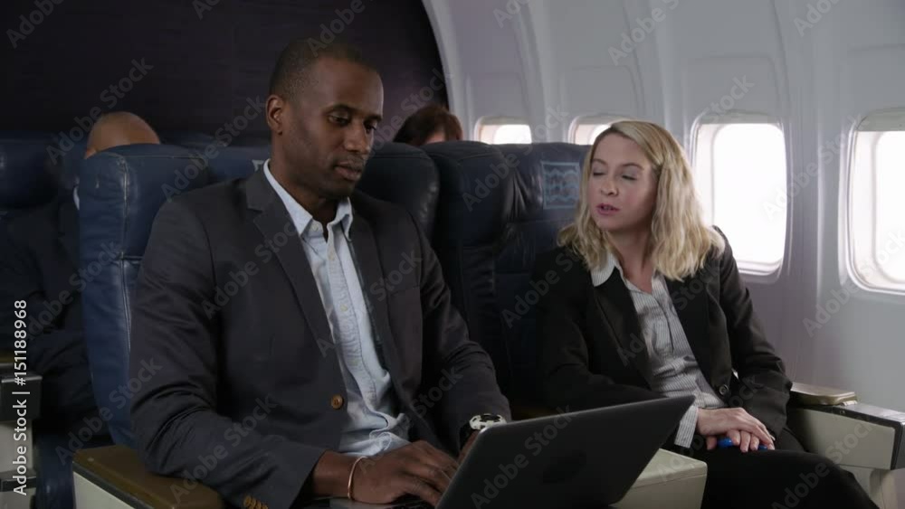 Business people working on airplane flight Business people working on airplane flight