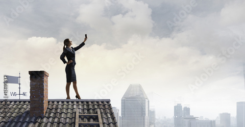 Woman on roof doing selfie