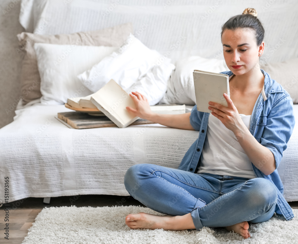 girl reading a book in a cozy room girl reading a book in a cozy room