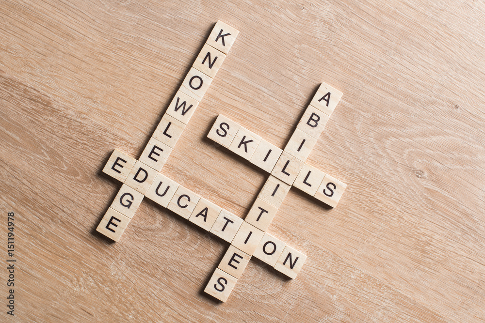 Conceptual keywords on wooden table with elements of game making crossword Conceptual keywords on wooden table with elements of game making crossword