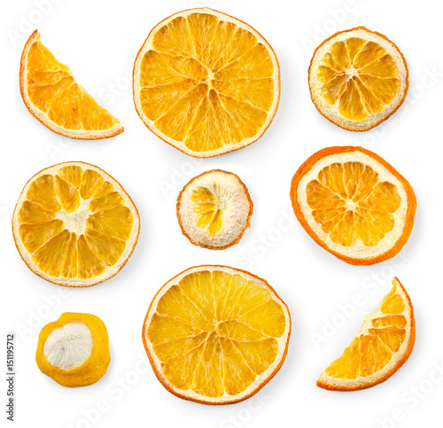 Set of dried slices and half a slice of orange and lemon, isolated on white background