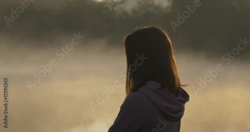 Silhouette of a woman on a background of fog