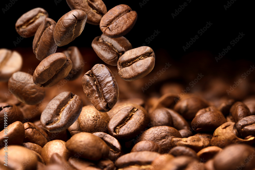 Obraz premium Spadające ziarna kawy. Ciemne tło z miejsca na kopię, zbliżenie