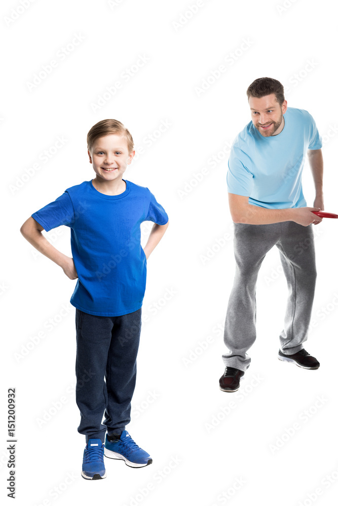 Father and son playing together with frisbee isolated on white Father and son playing together with frisbee isolated on white