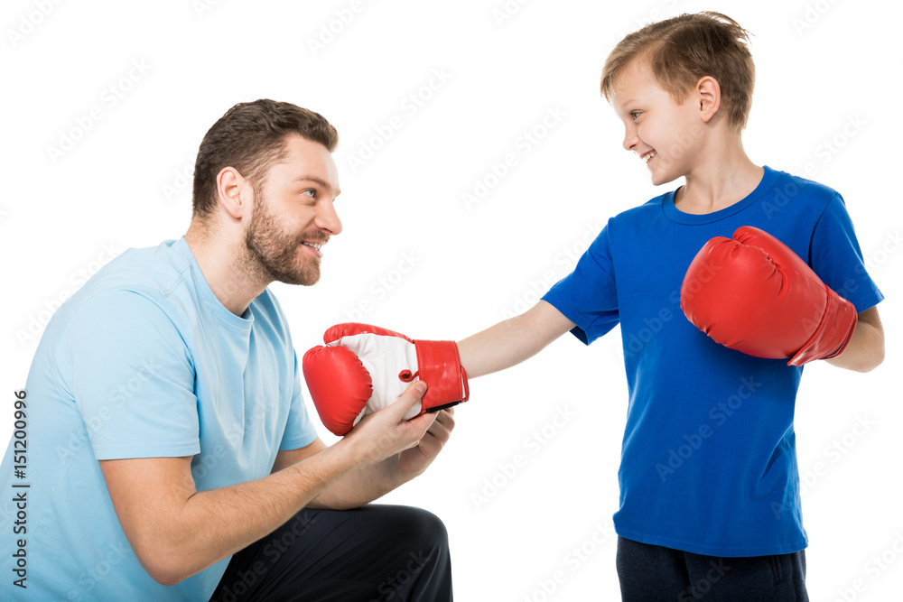 Happy father and son with boxer gloves isolated on white Happy father and son with boxer gloves isolated on white