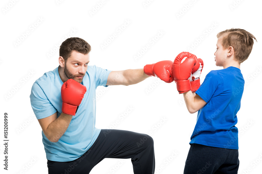 Happy father with son during boxing training isolated on white Happy father with son during boxing training isolated on white