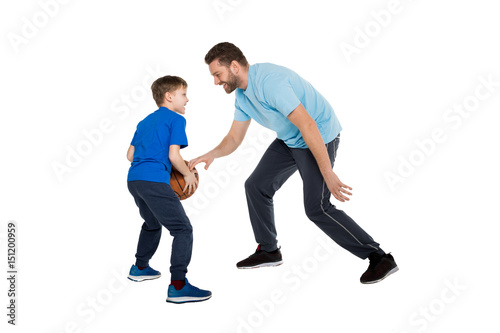 Happy father with son playing basketball isolated on white