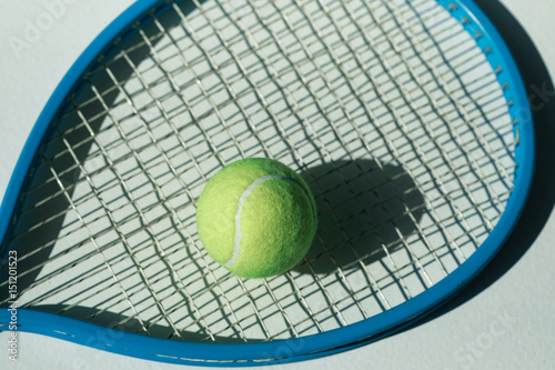 tennis racket and ball on the floor at room with daylight © LIGHTFIELD STUDIOS