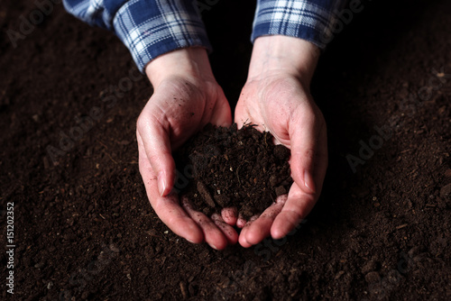 Female farmer handful of soil