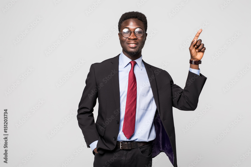 Businessman pointing at something on grey background Businessman pointing at something on grey background