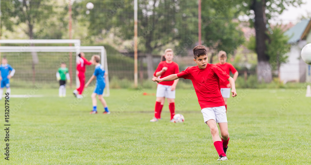 Kids soccer football - children players match on soccer field Kids soccer football - children players match on soccer field
