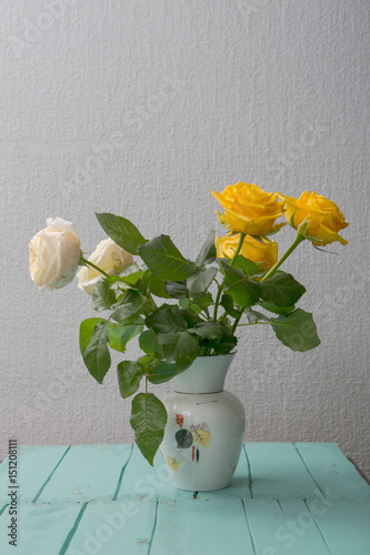 Rose placed on the desk in blue background photo