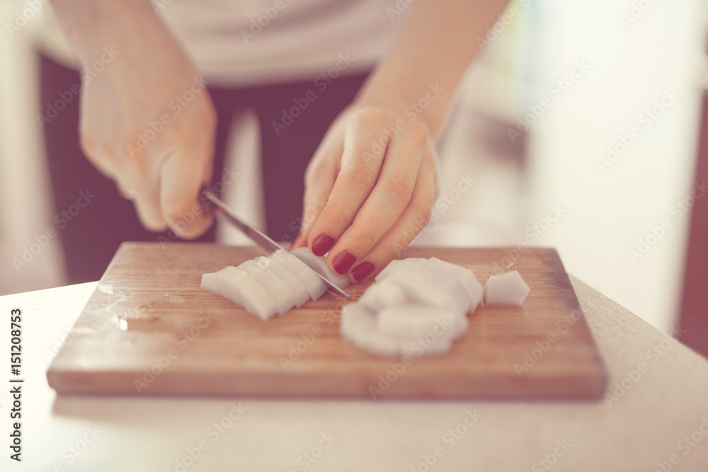 Cutting potatoes on close-up in real interior