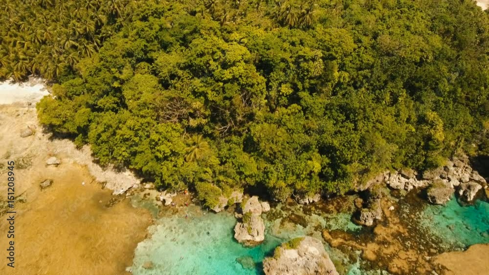 Tropical beach with natural rock pools in the Siargao Island. Aerial view Magpupungko natural rock pools. 4K, Travel concept, Aerial footage. Tropical beach with natural rock pools in the Siargao Island. Aerial view Magpupungko natural rock pools. 4K, Travel concept, Aerial footage.