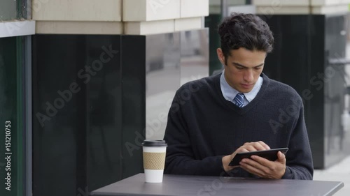 Young businessman using digital tablet at outdoorcafe photo