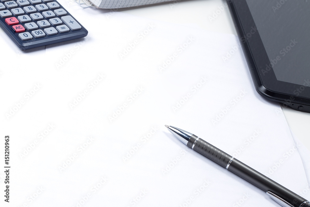 In the office on the table, a report, coffee, a tablet with a pen In the office on the table, a report, coffee, a tablet with a pen