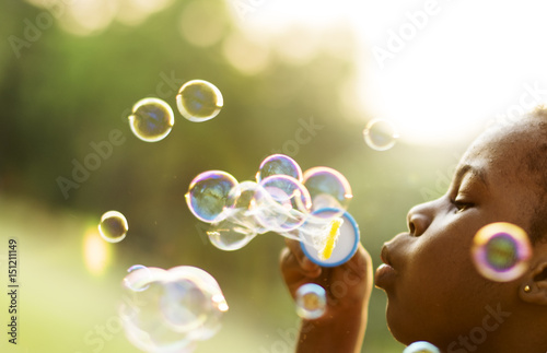 Foto Children is playing bubbles in a park