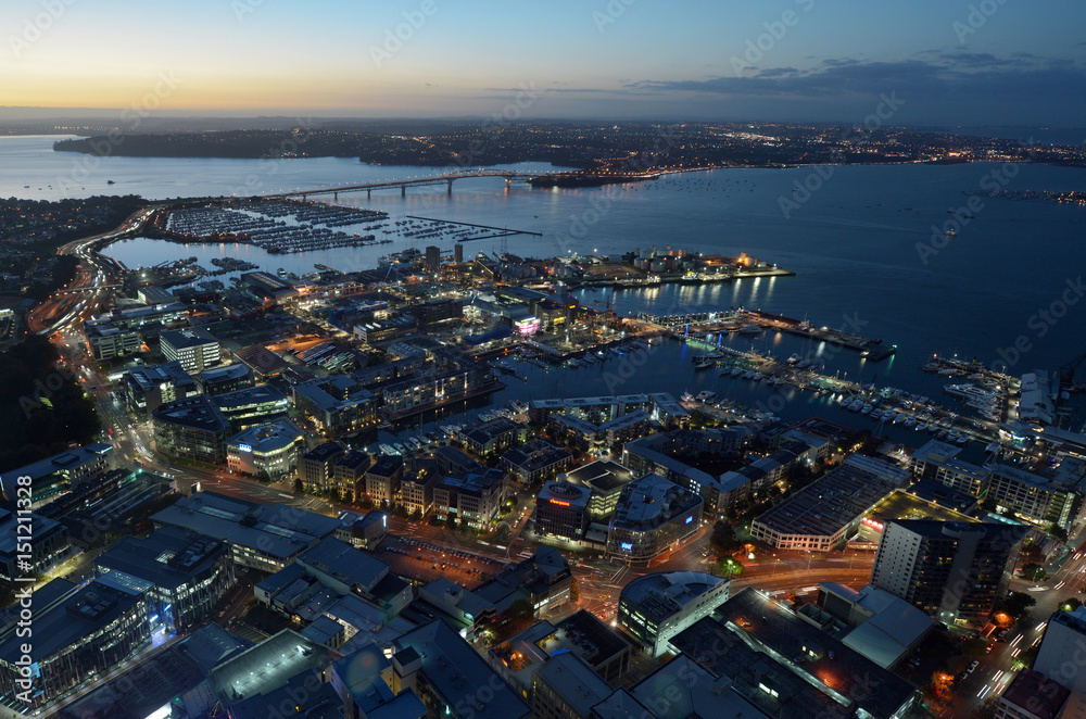 Aerial landscape view of Auckland city with Waitemata Harbour bridge at dusk