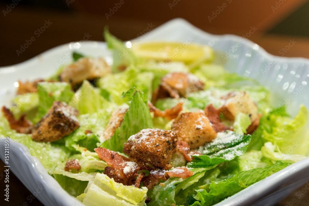 Fresh caesar salad with creamy dressing, croutons and bacon bits. Fresh caesar salad with creamy dressing, croutons and bacon bits.