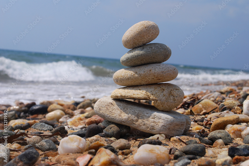Stack of stones on the rocky beach. Concept of balance and harmony at the sea Stack of stones on the rocky beach. Concept of balance and harmony at the sea