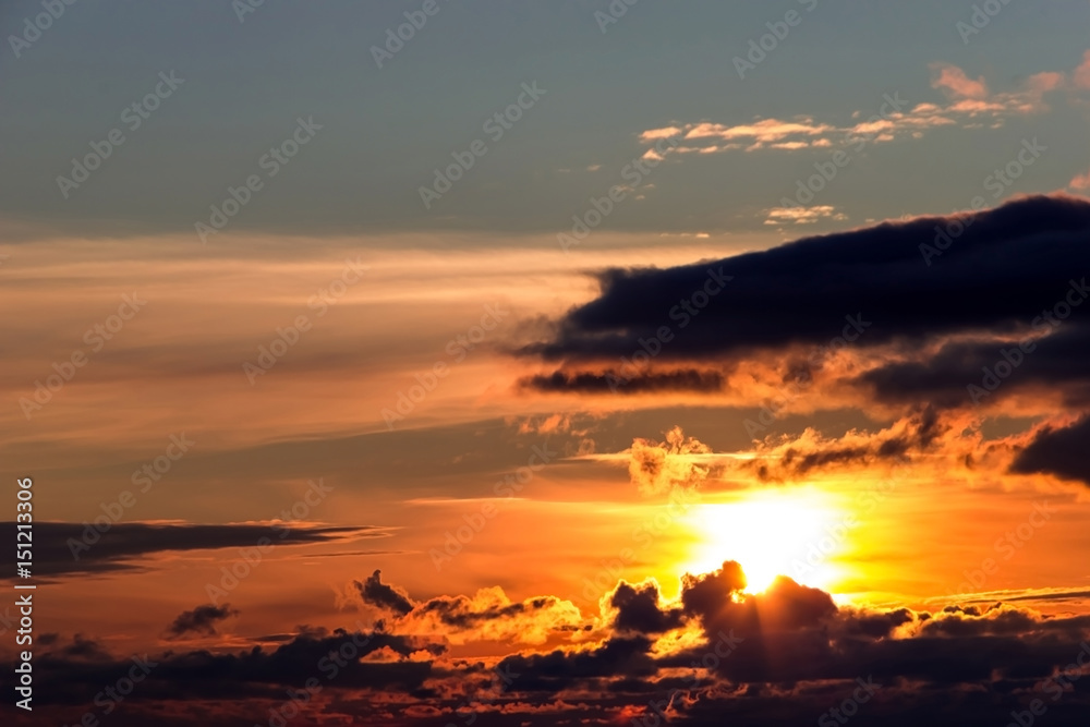 Fototapeta premium Bright sunset in the night cloudy sky