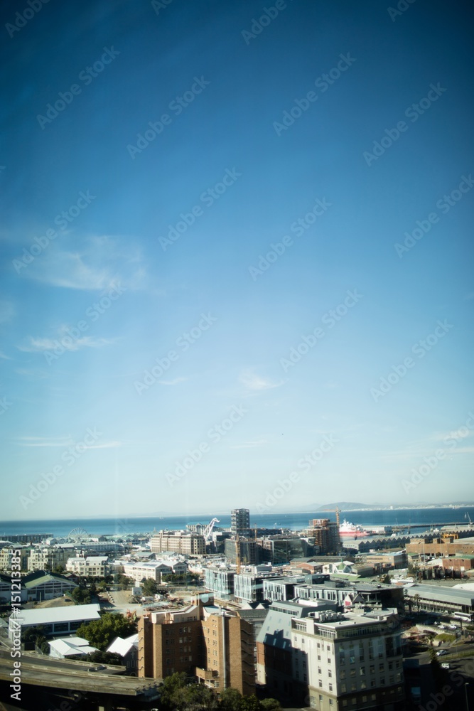 Cityscape against blue sky on sunny day