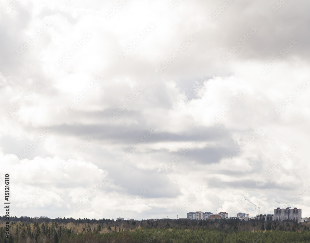 Cloudy sky over the city. Background of the overcast sky Cloudy sky over the city. Background of the overcast sky