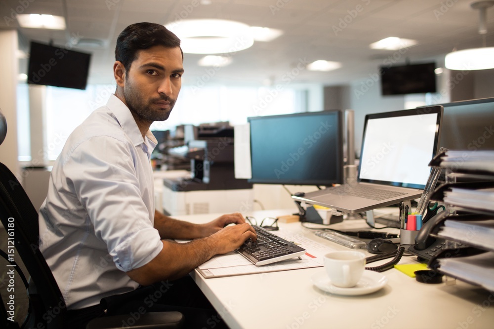 Serious business executive working at office desk Serious business executive working at office desk