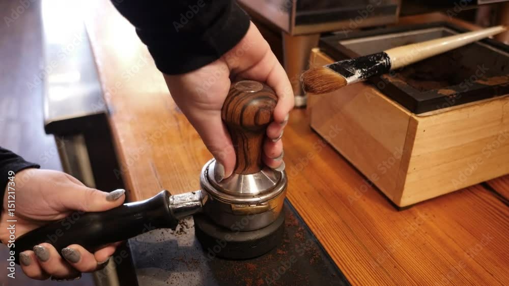 Woman making coffee at cafe